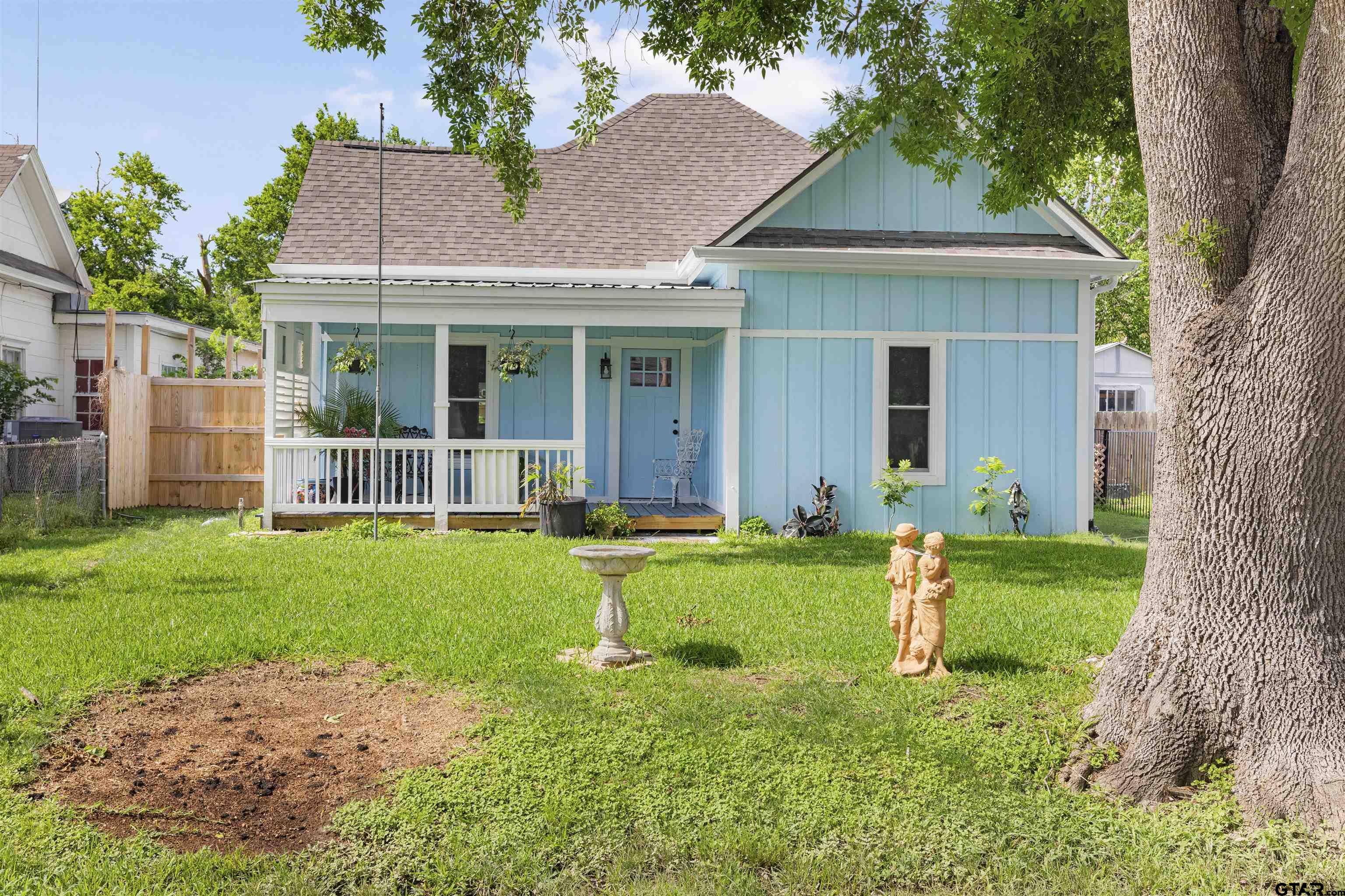 a front view of a house with a yard and porch