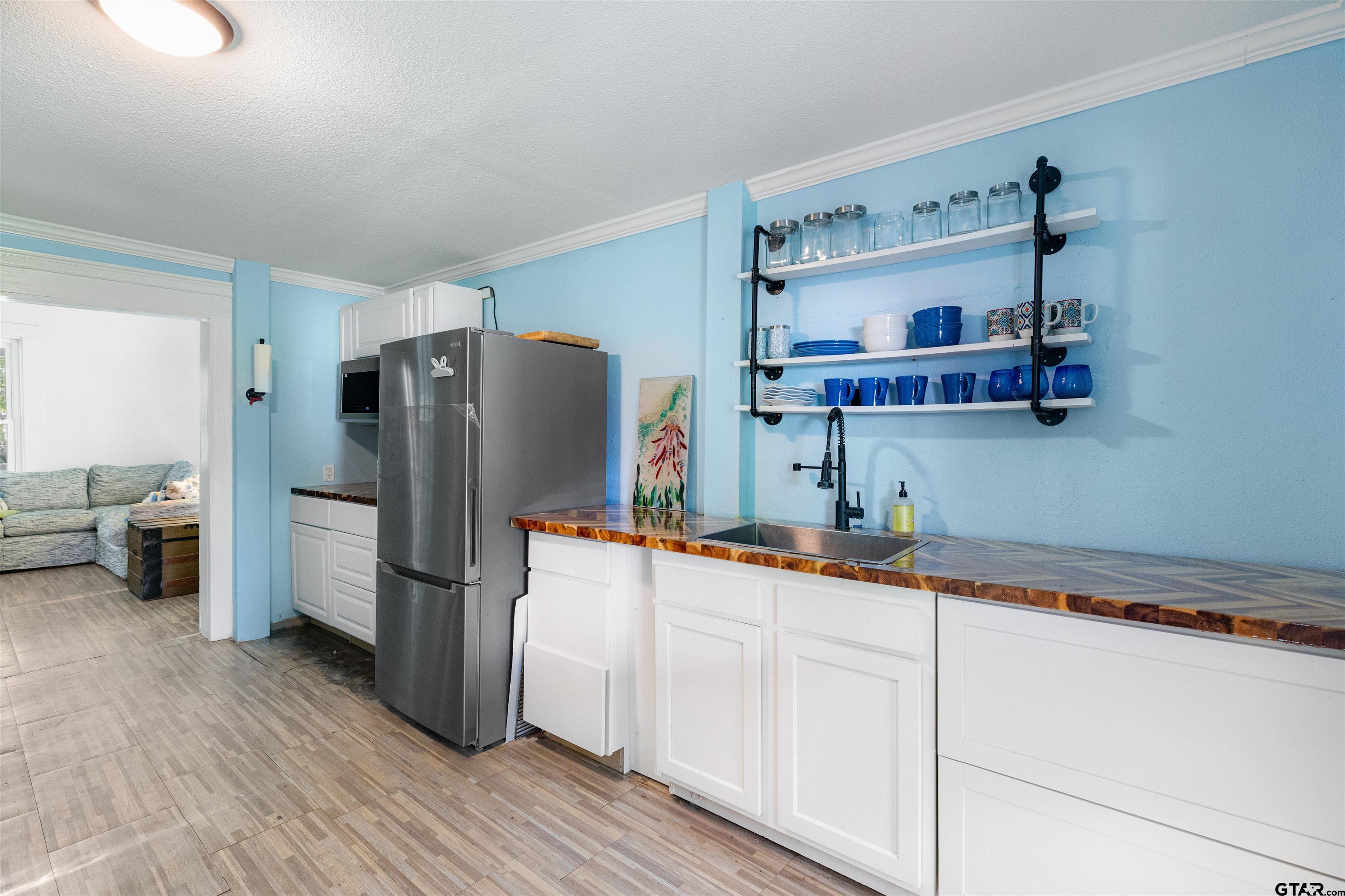 408 Morton Palacios, TX 77465 - Photo 11 of 29 a kitchen with stainless steel appliances a refrigerator and a sink