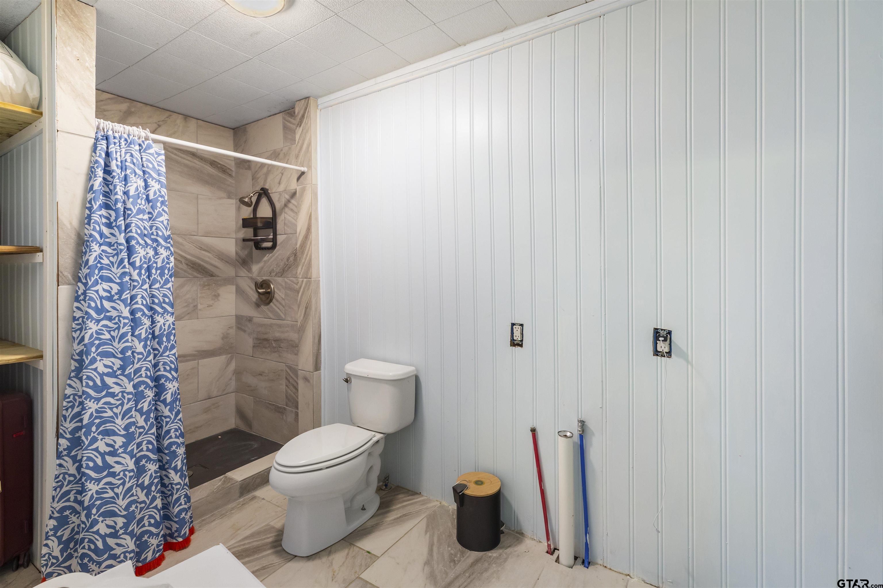 408 Morton Palacios, TX 77465 - Photo 15 of 29 a bathroom with a toilet and a shower