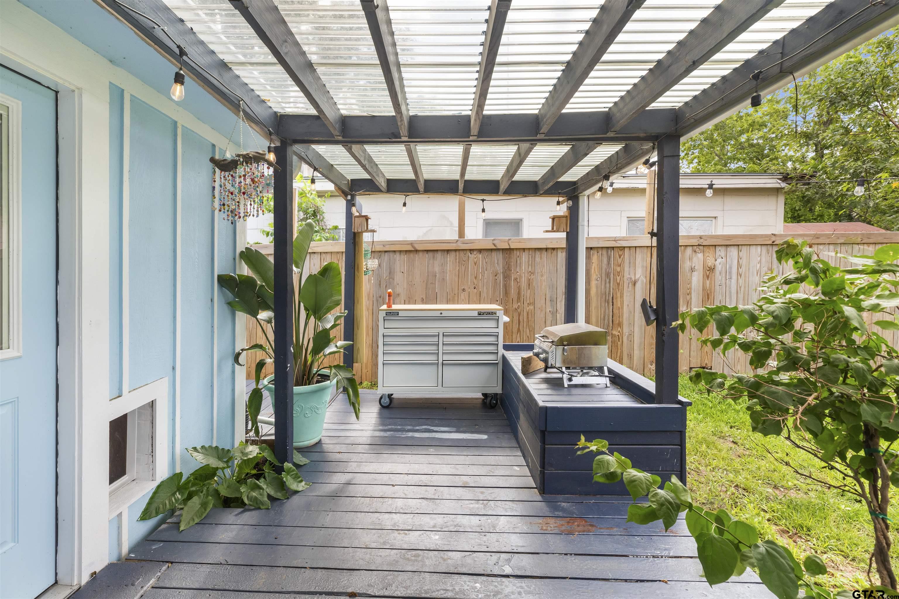 408 Morton Palacios, TX 77465 - Photo 17 of 29 a view of a patio with table and chairs potted plants with wooden floor