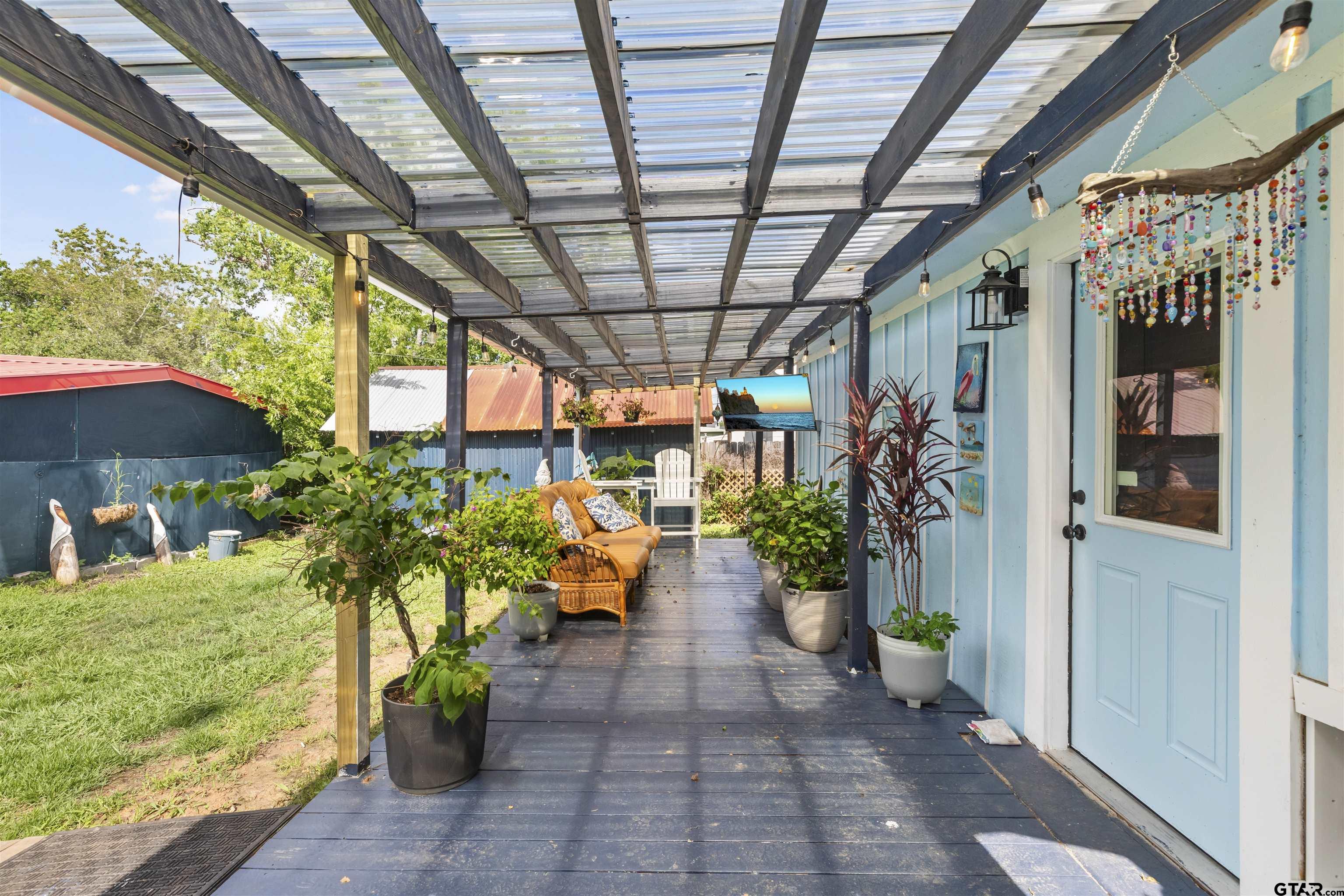 408 Morton Palacios, TX 77465 - Photo 19 of 29 a view of a porch with furniture and a potted plant