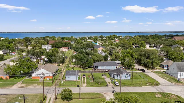 a aerial view of a house with a garden and lake view