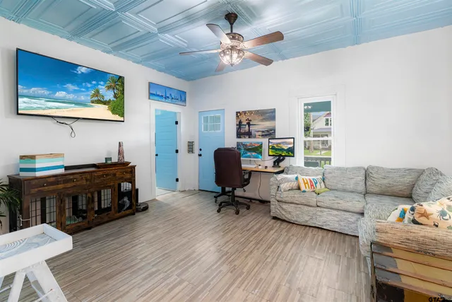 a living room with furniture and wooden floor
