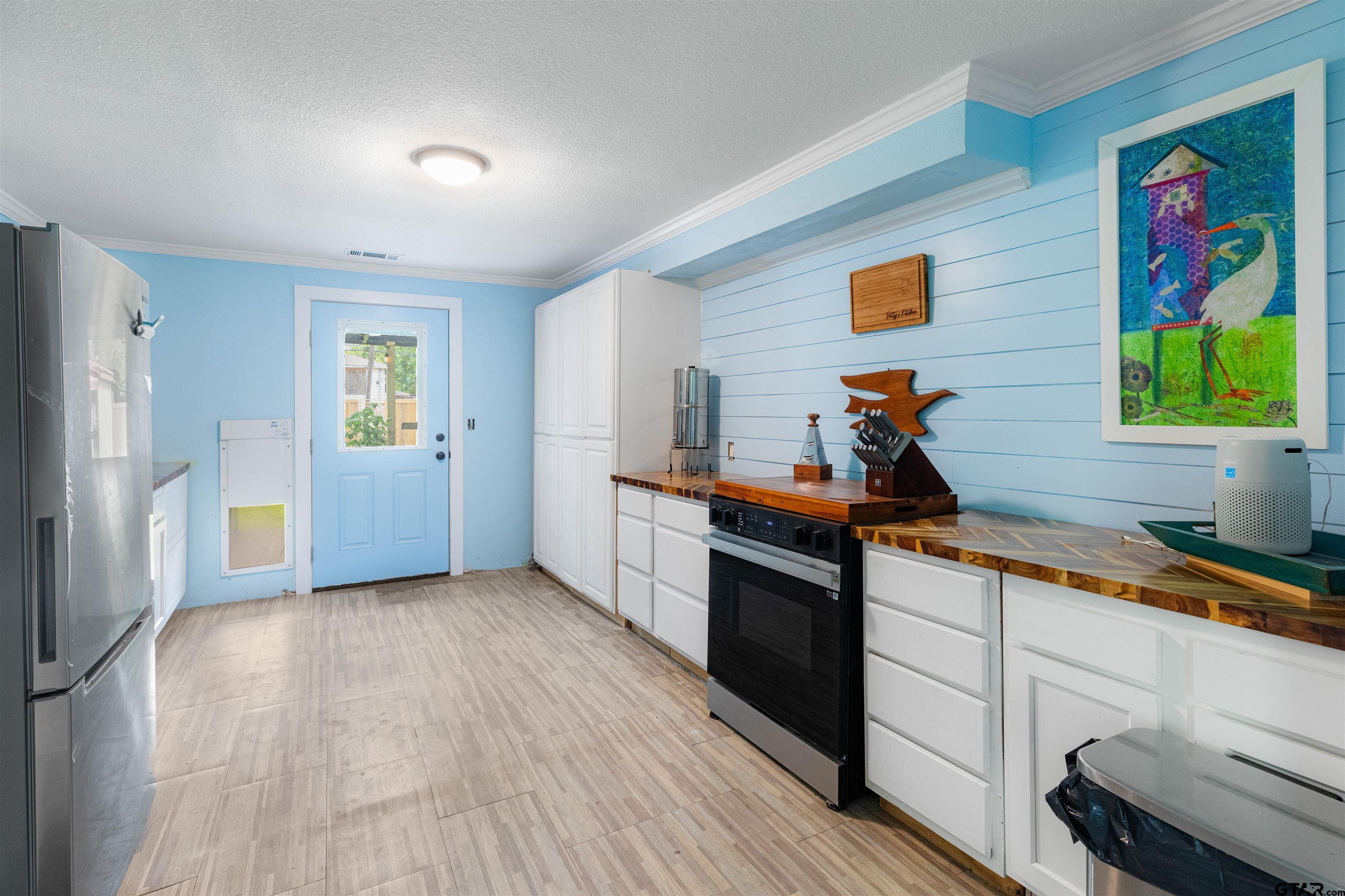 408 Morton Palacios, TX 77465 - Photo 10 of 29 a kitchen with stainless steel appliances granite countertop a sink and wooden floor