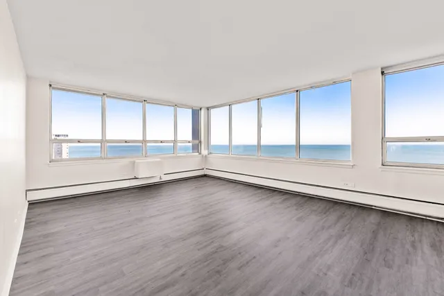a view of a hallway with wooden floor and closet