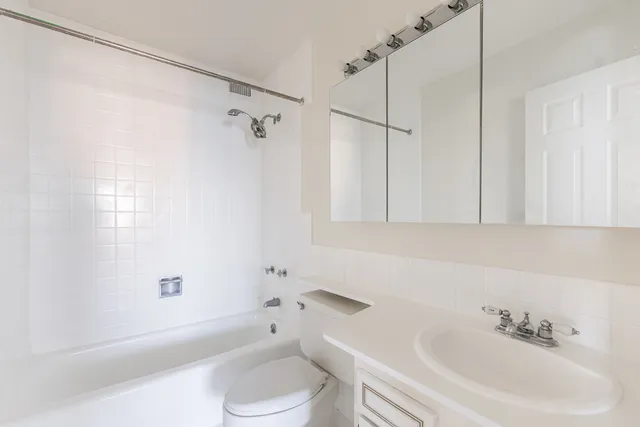 a bathroom with a sink a toilet and a shower