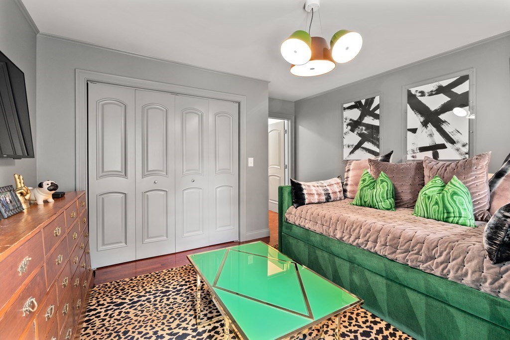 25 Westcliff Road Weston, MA 02493 - Photo 15 of 19 a bedroom with a bed and a chandelier