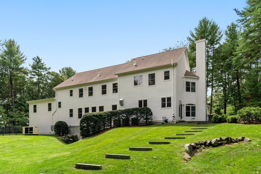 25 Westcliff Road Weston, MA 02493 - Photo 19 of 19 a view of a white house in front of a big yard with potted plants and big trees
