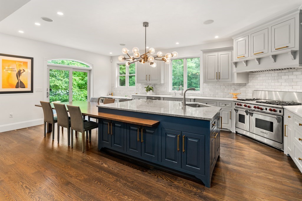 25 Westcliff Road Weston, MA 02493 - Photo 8 of 19 a kitchen with stainless steel appliances granite countertop wooden floors and white cabinets