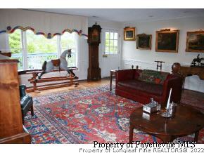 2467 Youngs Road Southern Pines, NC 28387 - Photo 6 of 12 a living room with furniture a flat screen tv and a large window