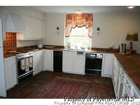 2467 Youngs Road Southern Pines, NC 28387 - Photo 9 of 12 a kitchen with a stove and a microwave
