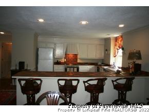 2467 Youngs Road Southern Pines, NC 28387 - Photo 10 of 12 a kitchen with a sink and cabinets