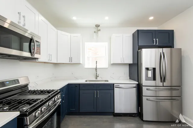 a kitchen with stainless steel appliances a refrigerator sink and microwave