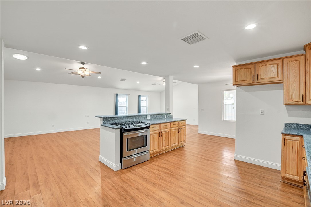 1810 Pinto Road Henderson, NV 89002 - Photo 20 of 53 A streamlined kitchen island with integrated range transitions seamlessly into open-concept living.