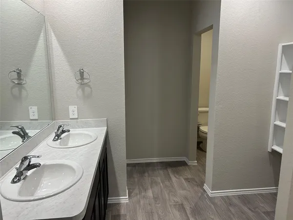 a view of walk in closet with empty racks