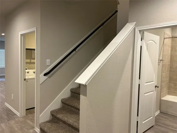 a view of entryway with stairs and wooden floor