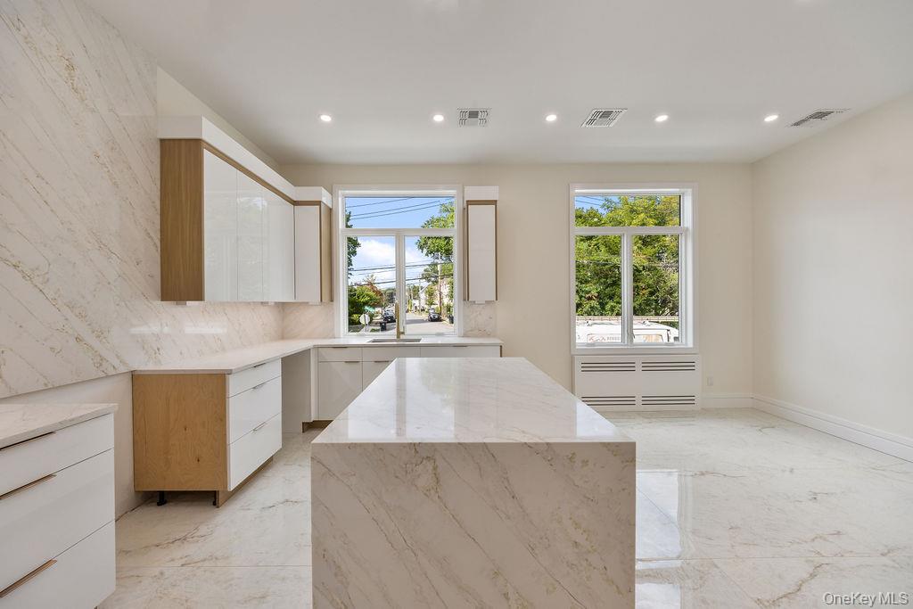 20 Singer Avenue, Unit 202 Spring Valley, NY 10977 - Photo 12 of 50 a large kitchen with kitchen island granite countertop a large window