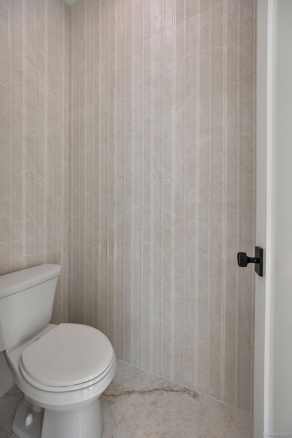 20 Singer Avenue, Unit 202 Spring Valley, NY 10977 - Photo 18 of 50 a white toilet sitting next to a shower curtain