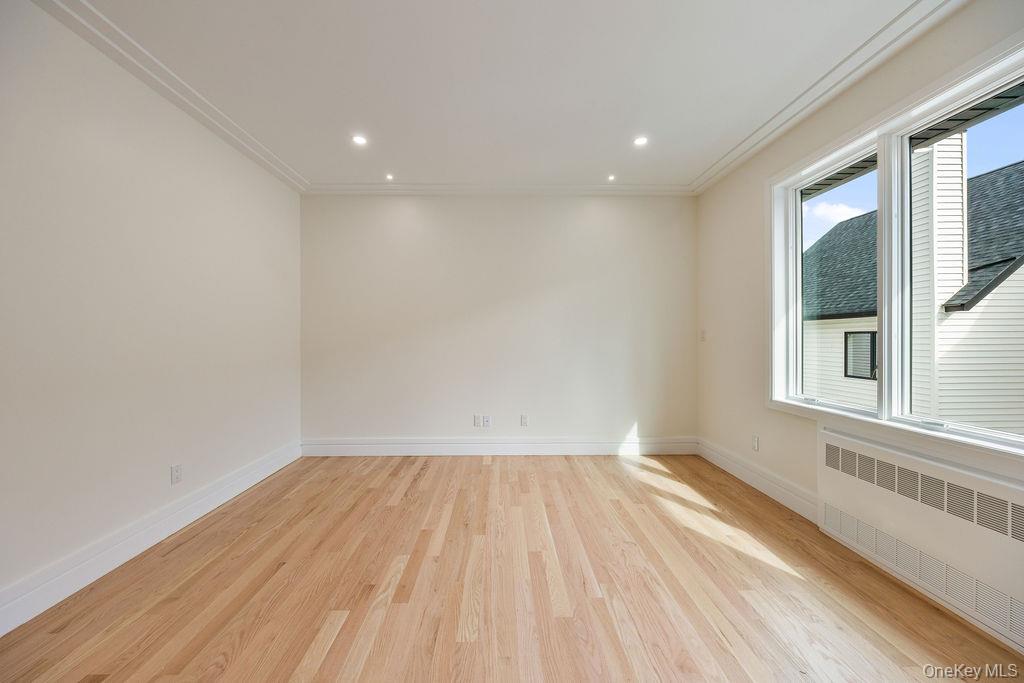 20 Singer Avenue, Unit 202 Spring Valley, NY 10977 - Photo 21 of 50 a view of empty room with wooden floor and fan