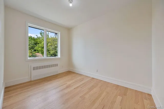 a bathroom with a sink and mirror with toilet