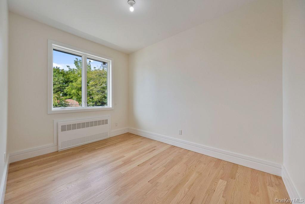 20 Singer Avenue, Unit 202 Spring Valley, NY 10977 - Photo 32 of 50 an empty room with wooden floor and windows