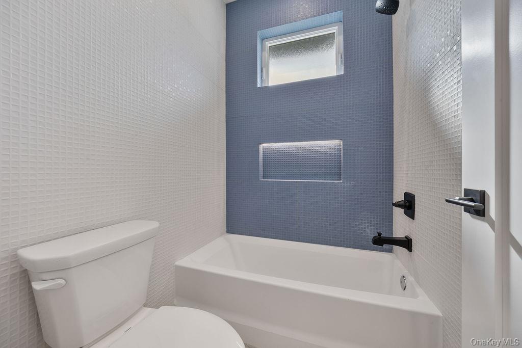 20 Singer Avenue, Unit 202 Spring Valley, NY 10977 - Photo 36 of 50 a white toilet sitting next to a bath tub