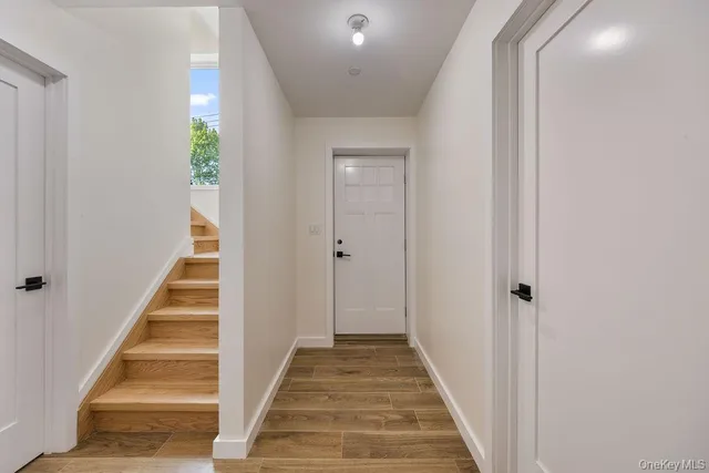 a view of room with wooden floor and fan