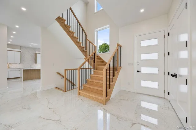 a view of entryway with stairs and a living room