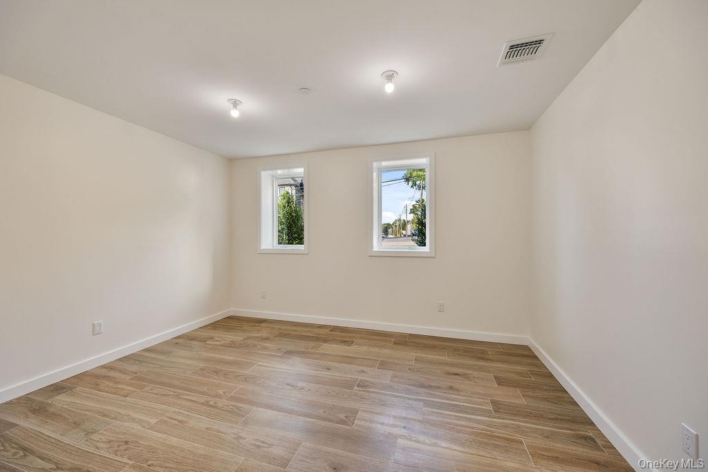 20 Singer Avenue, Unit 202 Spring Valley, NY 10977 - Photo 42 of 50 wooden floor in an empty room with a window