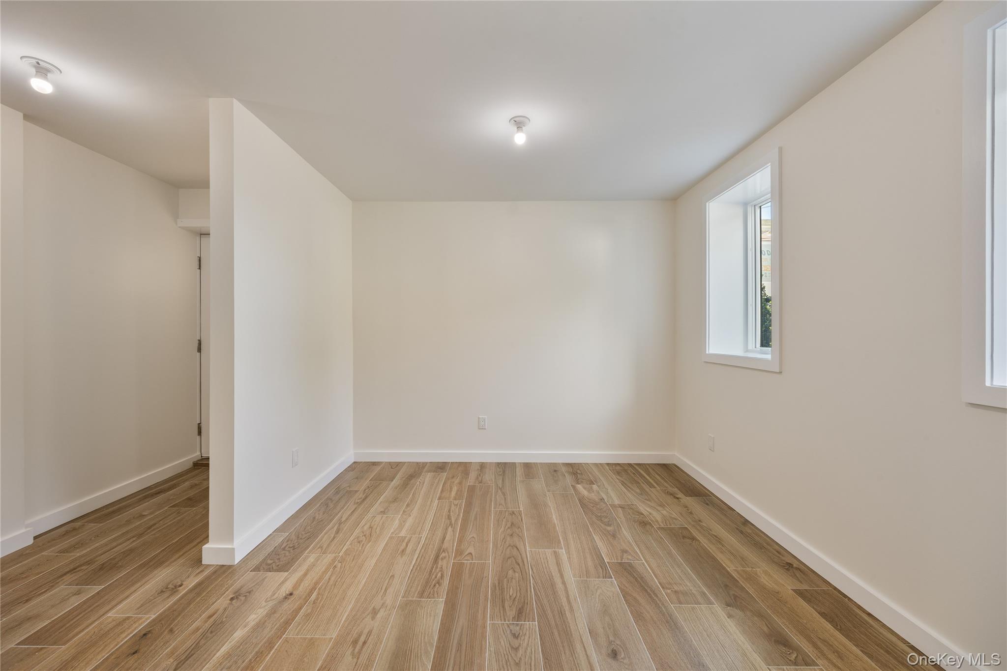20 Singer Avenue, Unit 202 Spring Valley, NY 10977 - Photo 43 of 50 a view of room with wooden floor and fan