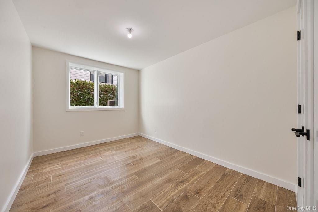 20 Singer Avenue, Unit 202 Spring Valley, NY 10977 - Photo 47 of 50 wooden floor in an empty room with a window