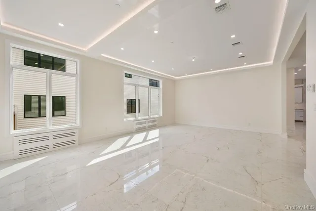a view of cabinets a sink wooden floor and a window