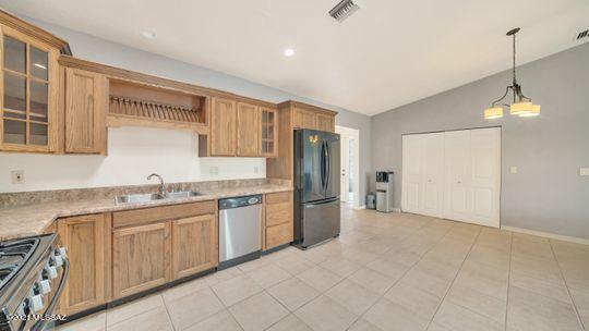 401 Rio Rico Drive Rio Rico, AZ 85648 - Photo 17 of 31 a kitchen with granite countertop a sink and refrigerator