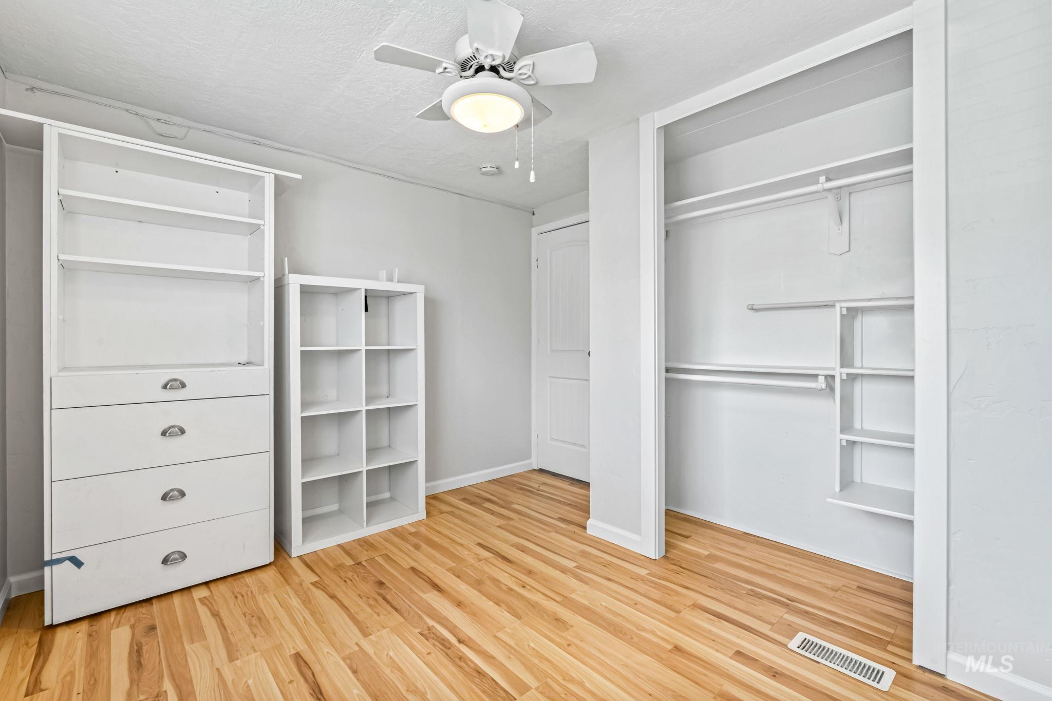 5015 East Ustick Road, Unit 181 Caldwell, ID 83605 - Photo 12 of 28 Unfurnished bedroom with light wood finished floors, ceiling fan, a textured ceiling, and a closet