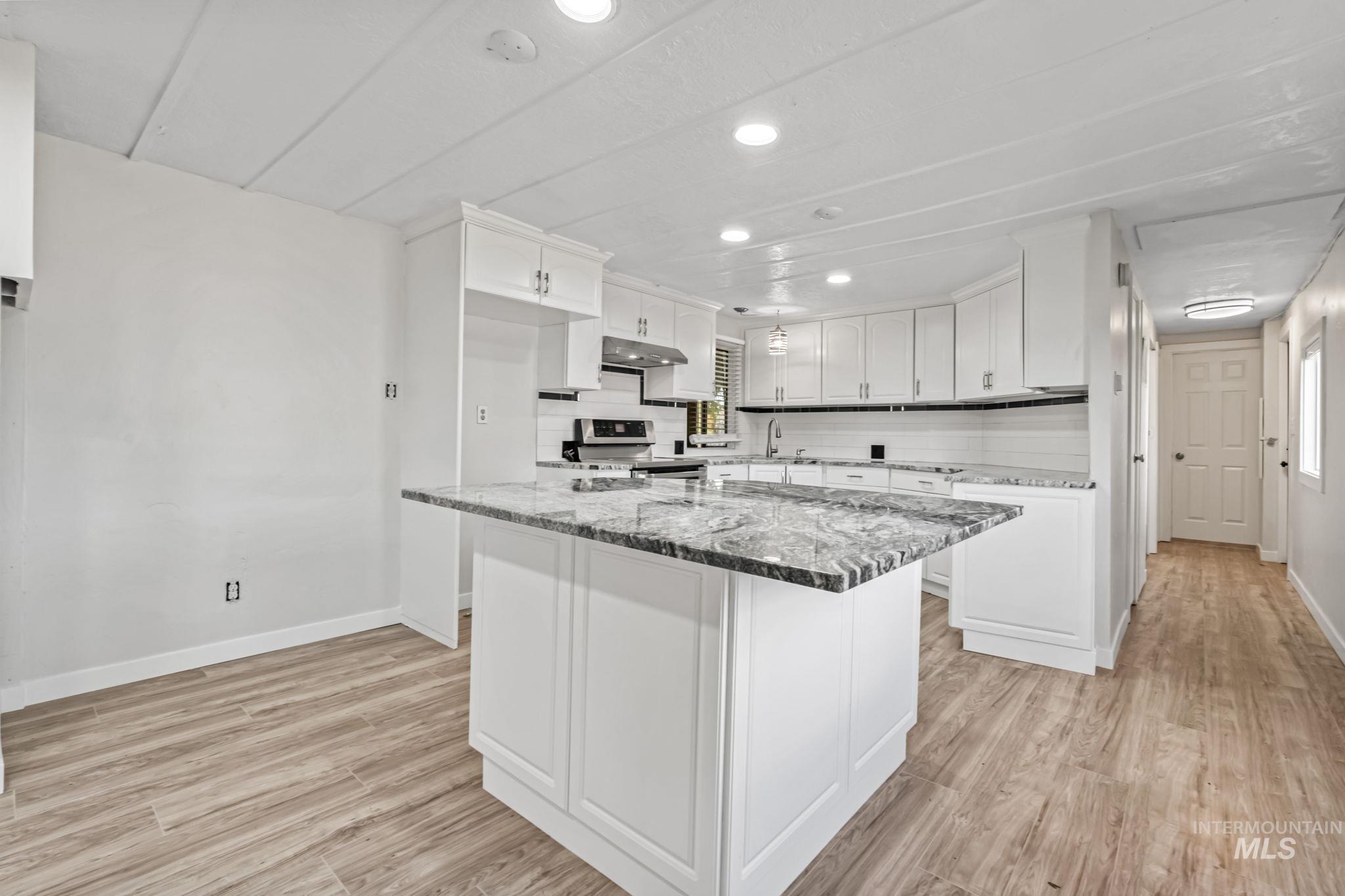 5015 East Ustick Road, Unit 181 Caldwell, ID 83605 - Photo 14 of 28 Kitchen featuring white cabinetry, recessed lighting, electric stove, light stone countertops, and light wood-type flooring