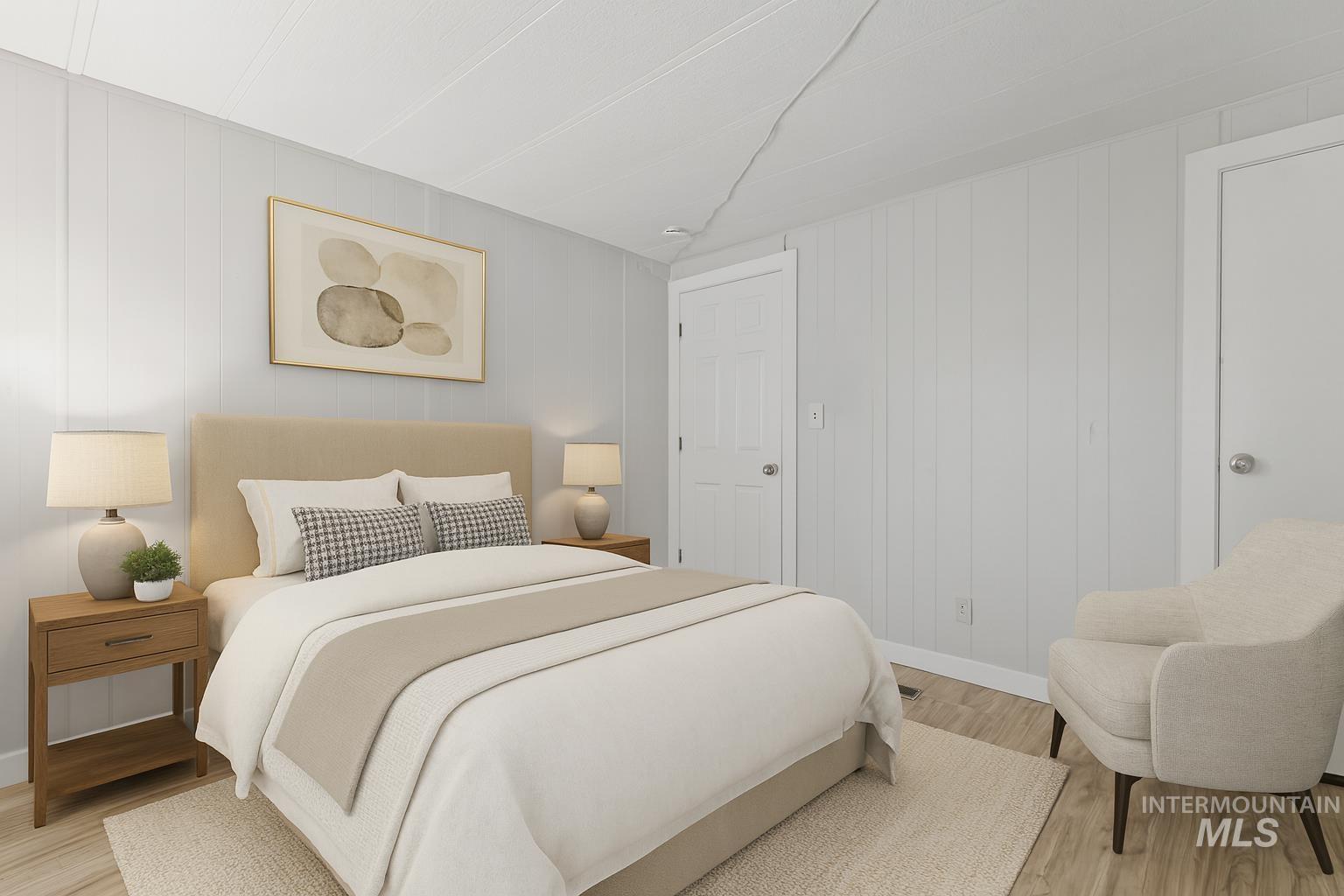 5015 East Ustick Road, Unit 181 Caldwell, ID 83605 - Photo 8 of 28 Bedroom featuring light wood-style flooring and wooden walls