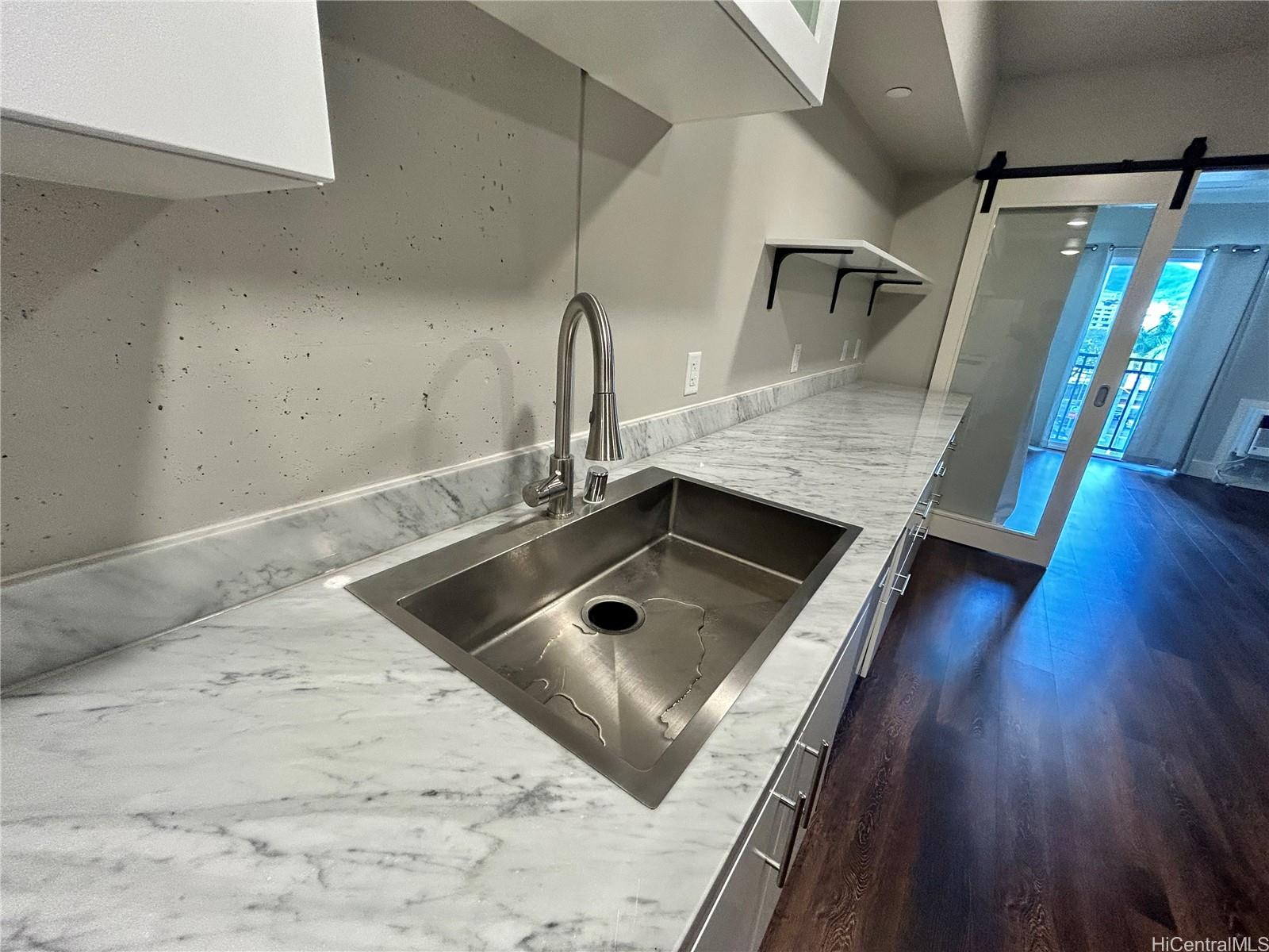 803 Waimanu Street, Unit 401 Honolulu, HI 96813 - Photo 3 of 18 a kitchen with a sink stove and refrigerator