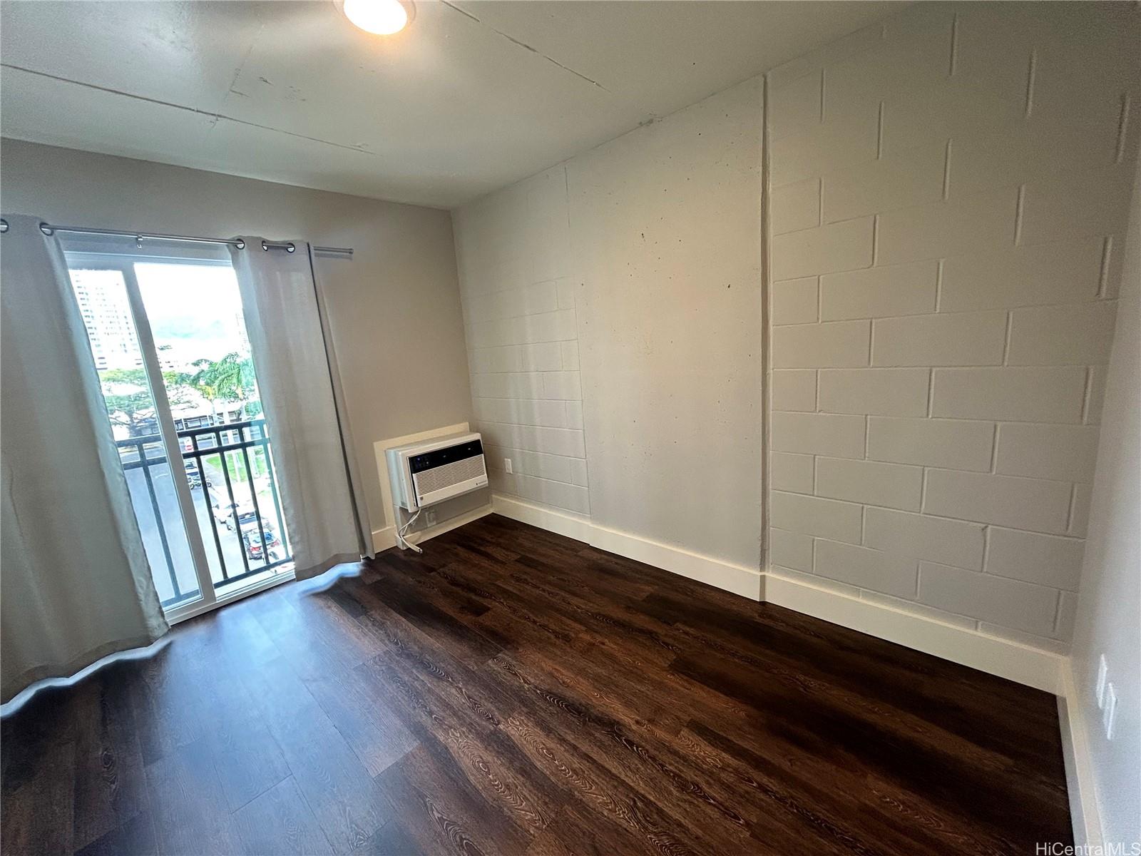 803 Waimanu Street, Unit 401 Honolulu, HI 96813 - Photo 5 of 18 a view of an empty room and wooden floor
