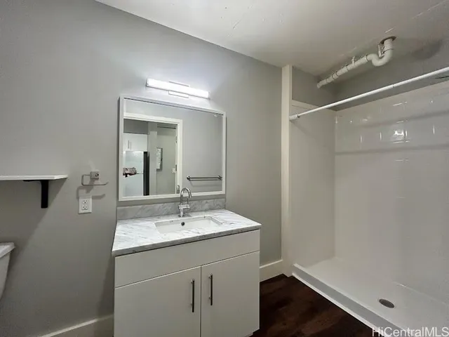 a bathroom with a sink vanity and a mirror