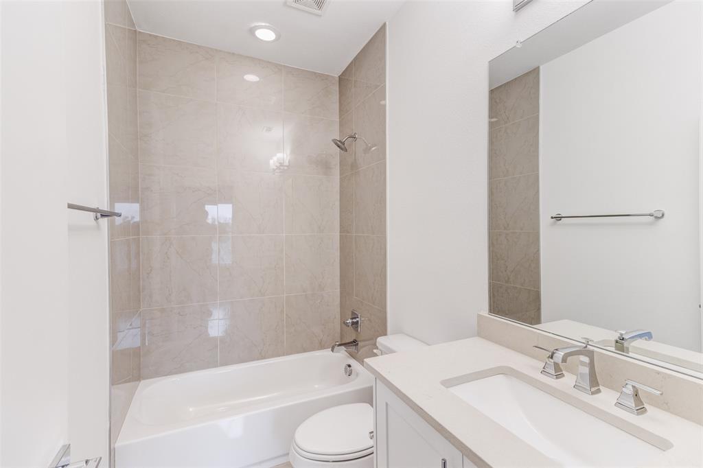 1925 California Drive, Unit 3 Dallas, TX 75204 - Photo 22 of 33 a bathroom with a granite countertop sink toilet and shower