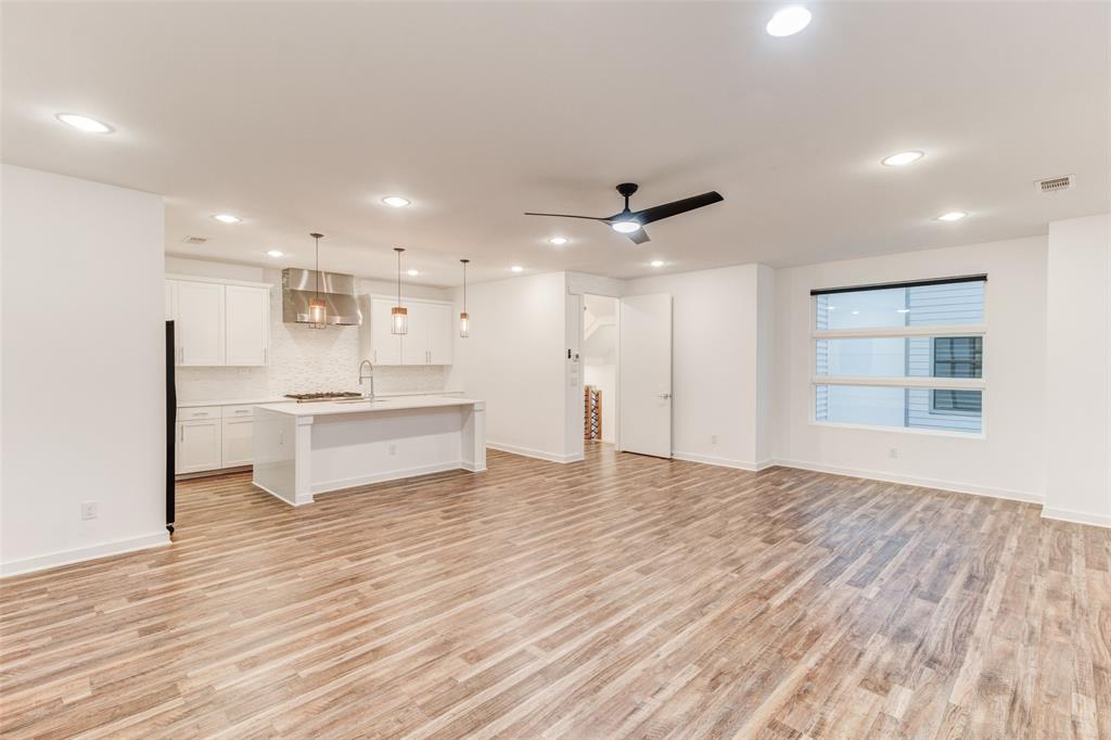 1925 California Drive, Unit 3 Dallas, TX 75204 - Photo 6 of 33 a view of kitchen with kitchen island wooden floor center island and stainless steel appliances