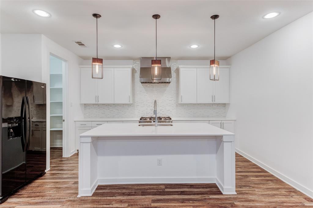 1925 California Drive, Unit 3 Dallas, TX 75204 - Photo 7 of 33 a view of a kitchen with stainless steel appliances granite countertop a stove a sink and a wooden floor