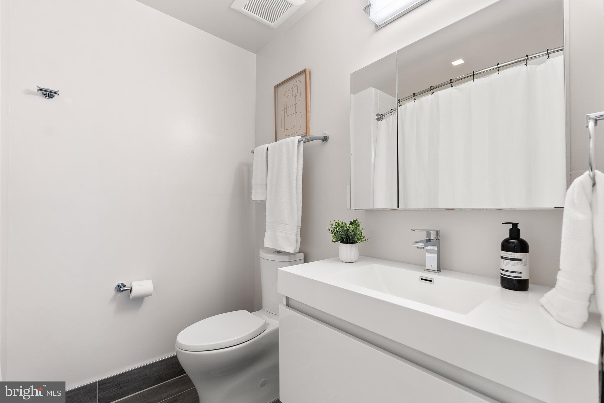 1001 Monroe Street Northwest, Unit 1 Washington, DC 20010 - Photo 12 of 23 a bathroom with a sink a toilet and shower