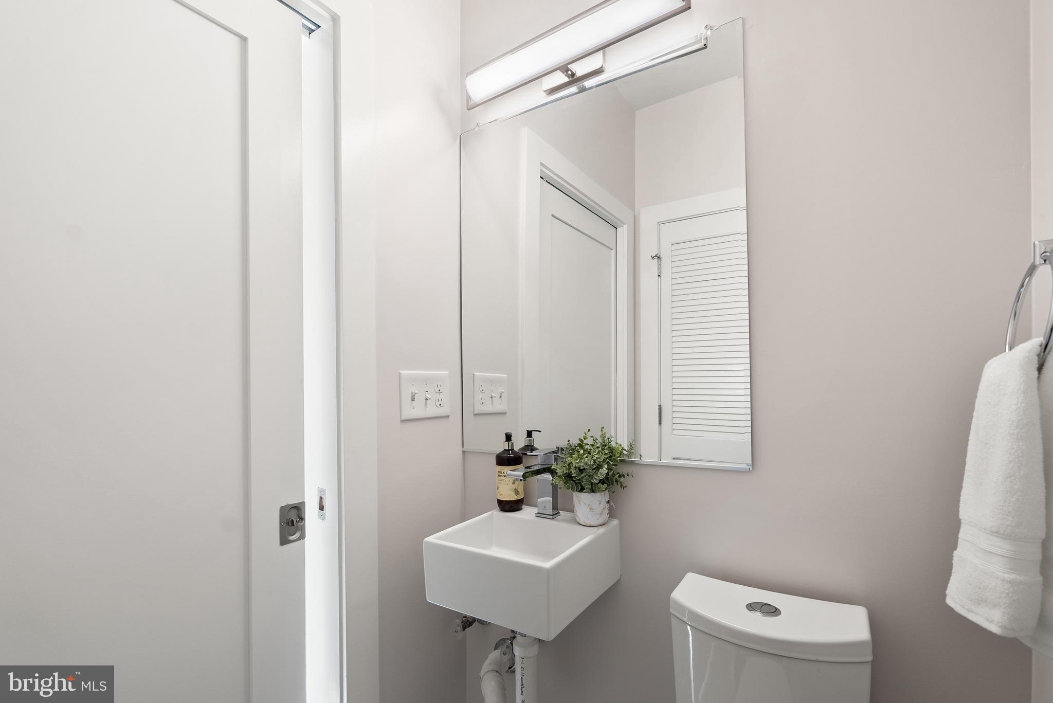 1001 Monroe Street Northwest, Unit 1 Washington, DC 20010 - Photo 7 of 23 a bathroom with a sink a toilet and mirror