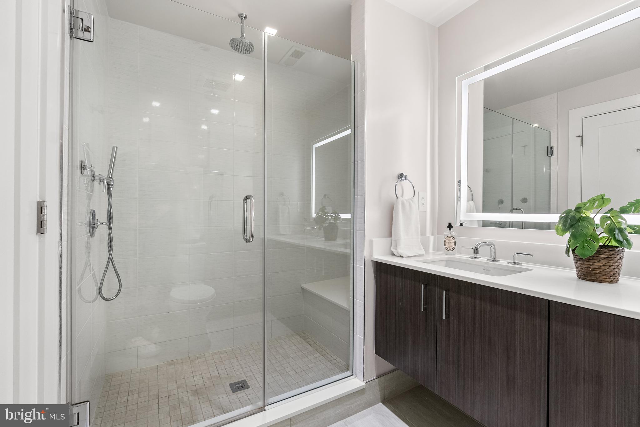 1001 Monroe Street Northwest, Unit 1 Washington, DC 20010 - Photo 10 of 23 a bathroom with a shower sink vanity and mirror