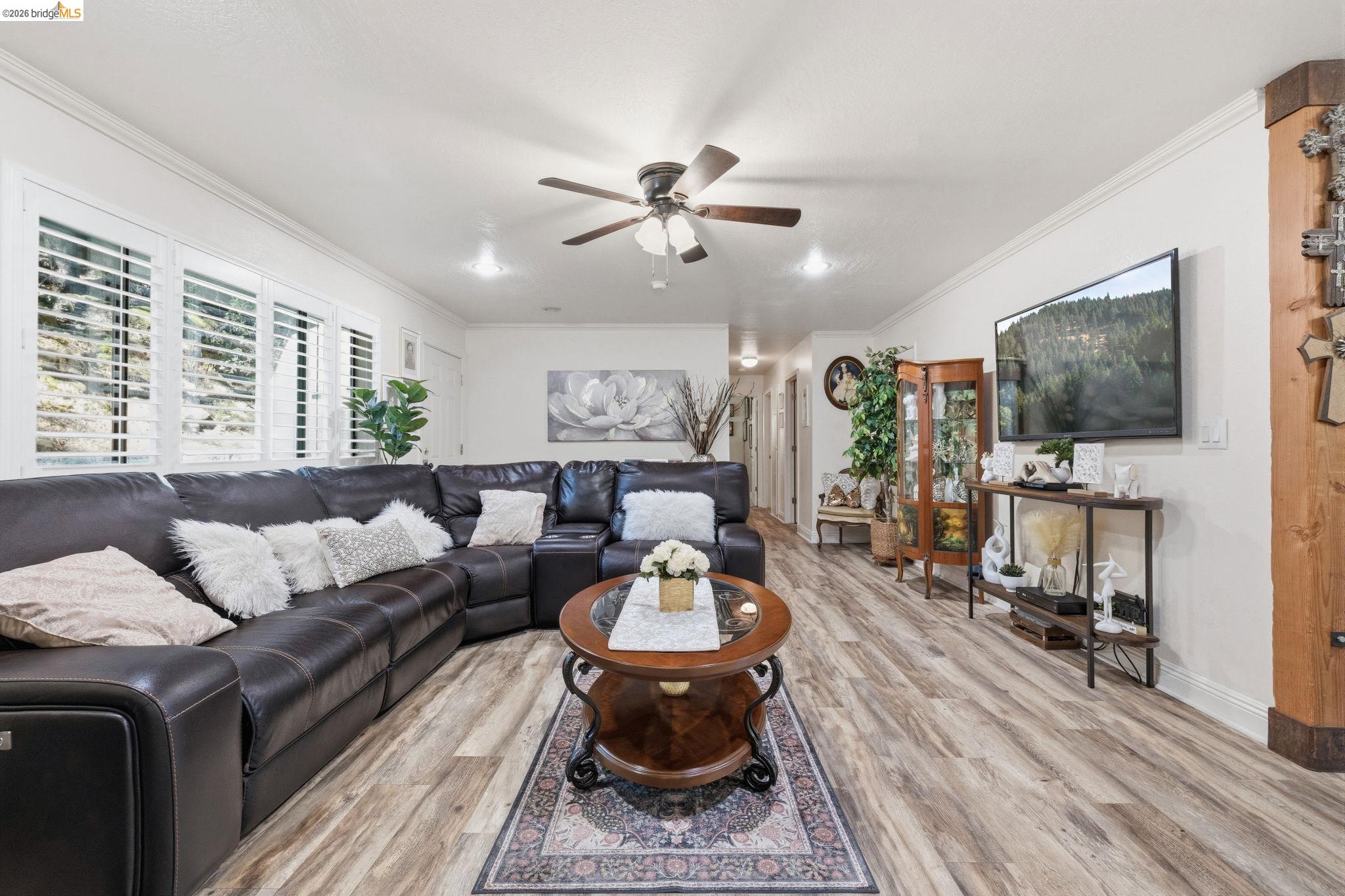 21999 Fallview Drive Sonora, CA 95370 - Photo 11 of 36 Living room featuring light wood-type flooring, ceiling fan, and ornamental molding