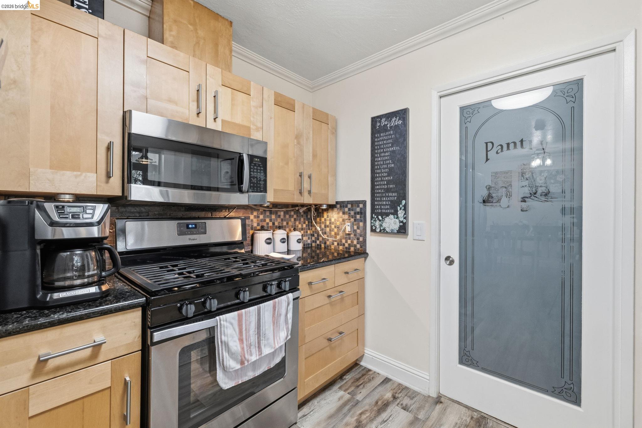 21999 Fallview Drive Sonora, CA 95370 - Photo 12 of 36 Kitchen with light wood finish cabinetry, stainless steel appliances, dark stone countertops, light wood-style floors, and tasteful backsplash