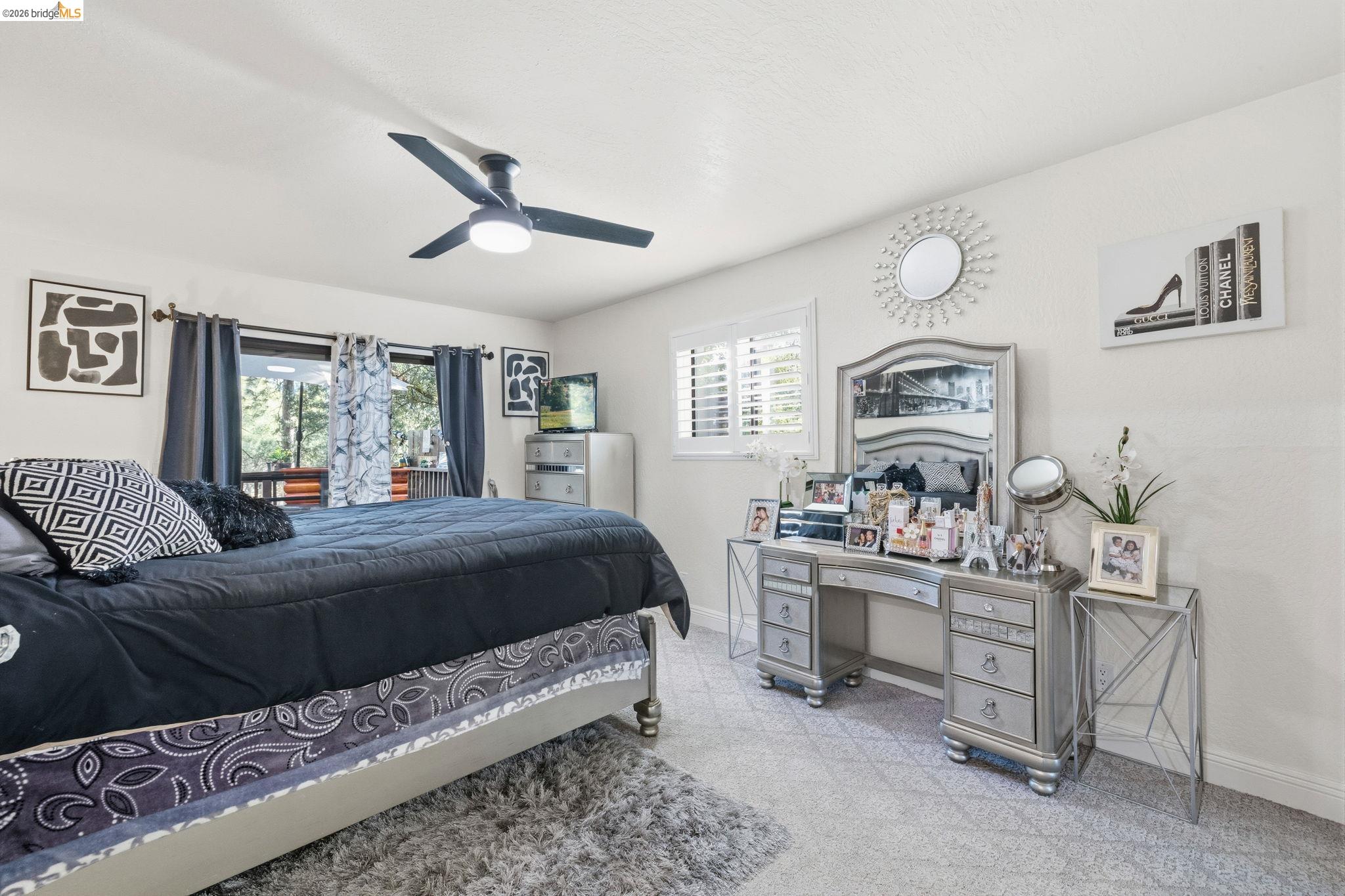 21999 Fallview Drive Sonora, CA 95370 - Photo 16 of 36 Bedroom featuring multiple windows, ceiling fan, and access to outside