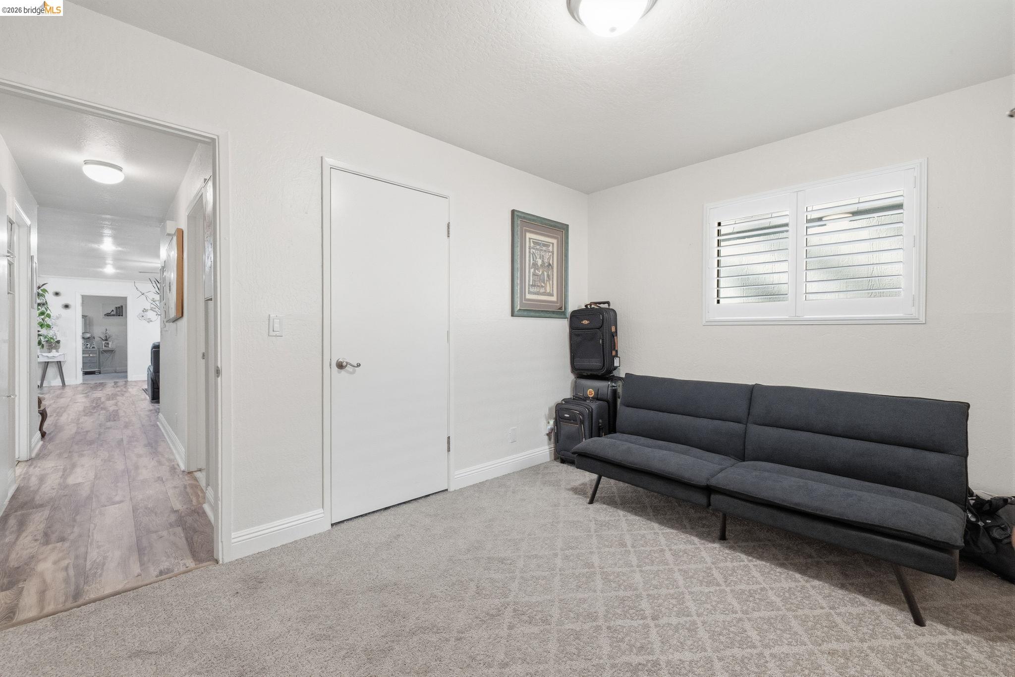 21999 Fallview Drive Sonora, CA 95370 - Photo 22 of 36 Living area with light carpet and baseboards