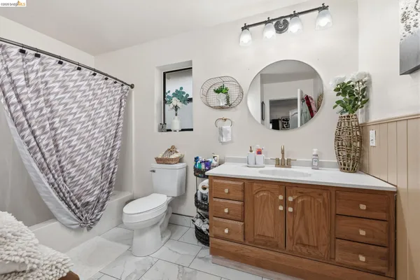 a bathroom with a toilet a sink and a mirror